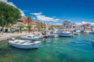 a group of boats docked in a harbor at Apartment Red Rose in Kaštela