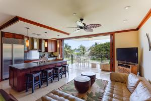 a kitchen and living room with a bar and a balcony at Third Floor villa Ocean View - Beach Tower at Ko Olina Beach Villas Resort in Kapolei