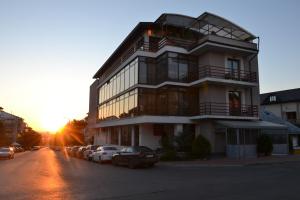 a building with cars parked in front of it at Santa Fe in Suceava