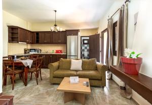 a living room and kitchen with a couch and a table at Douliana Villas in Douliana