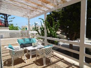 a patio with a table and chairs and a couch at Magnolia Apartment in Protaras