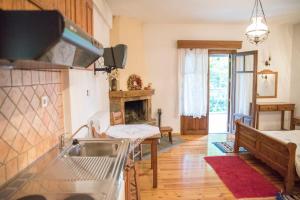 a kitchen with a sink and a stove at Archontiko Christodoulou in Vronteró