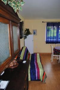 a living room with a desk and a bed in it at Holiday Home Dželalija in Stara Sušica