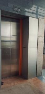 a metal door in a building with a sign on it at Hotel Ravi Mayur International in Chitradurga