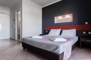 a bedroom with a large bed with a red headboard at Zante Calinica Hotel in Tsilivi