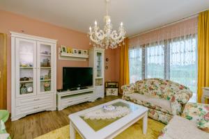 a living room with a couch and a tv at RUSTIC HOUSE LEKOVIĆ in Virpazar