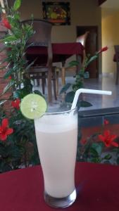 a drink with a lime in a glass on a table at Maha Neka Villa in Sidemen