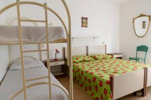 a bedroom with two bunk beds and a ladder at Appartamenti Padoan in Sottomarina