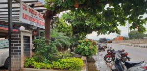 a group of motorcycles parked in front of a building at Hotel Ravi Mayur International in Chitradurga +22 photos