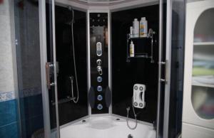 a bathroom with a shower with a controller in it at Family Seaview Villa 1 in Trabzon