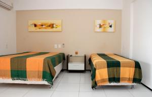 two beds sitting next to each other in a room at Pousada Costa Marina in Fortaleza +64 photos