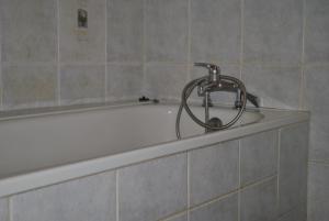 a bath tub with a faucet on top of it at Apartament Gorczewska Przy Metrze in Warsaw