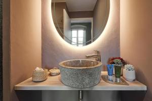 a bathroom with a sink and a mirror at La Indiana de Begur, Petit Hotel Boutique in Begur