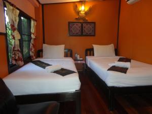 Postel nebo postele na pokoji v ubytování Baanfai Guesthouse Chiangkhong