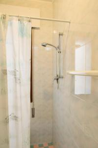 a shower with a shower curtain in a bathroom at Appartamenti Padoan in Sottomarina +69 photos