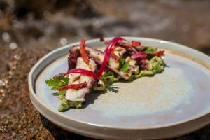 a plate of food with chicken and vegetables on it at Hotel Le Maquis in Porticcio