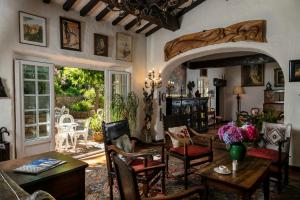 a living room with a table and chairs at Hotel Le Maquis in Porticcio