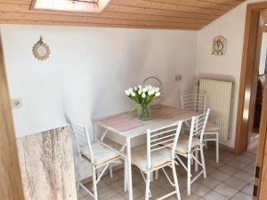 a dining room with a table and chairs at Bavarian Holiday Home - A94 Autobahn in Oberheldenstein