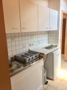 a kitchen with a sink and a stove top oven at Bavarian Holiday Home - A94 Autobahn in Oberheldenstein