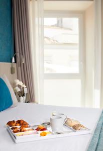 a tray of food on a table in a hotel room at Occidental Faro in Faro