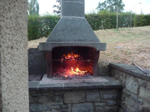 an outdoor brick oven with a fire in it at Capannina Vesale in Sestola