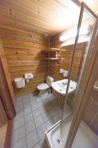 a wooden bathroom with a toilet and a sink at Dombås Hostel in Dombås