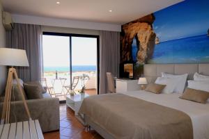 a bedroom with a bed and a view of the ocean at Lagos Atlantic Hotel in Lagos +37 photos