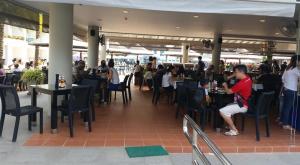 a group of people sitting at tables in a restaurant at GrandBlue Condominium 201 in Mae Pim