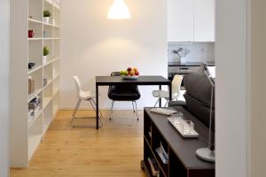 a kitchen and dining room with a table and chairs at Go Native Lisbon - VIP Principe Real in Lisbon