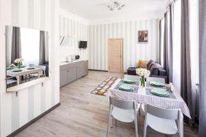 a living room with a dining table and a kitchen at #1 APARTMENT in Lviv