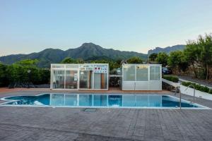 a house with a swimming pool with mountains in the background at Dulce Valle Villas and Spa in El Paso