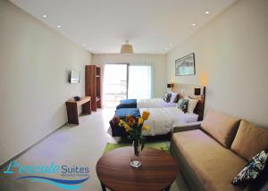 a room with a bed and a couch and a table at L'escale Suites Résidence Hôtelière By 7AV HOTELS in Mohammedia