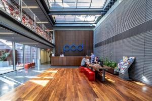 a lobby with people sitting at a table in a building at Pod Brooklyn in Brooklyn