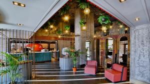 eine Lobby eines Gebäudes mit roten Stühlen und Pflanzen in der Unterkunft Zimmer Bosphorus Hotel in Istanbul