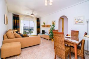 a living room with a couch and a table at Casa Roka in Campoamor