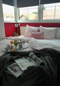 a bed with a tray of food on top of it at Stylish Studio In The Heart of Varaždin in Varaždin