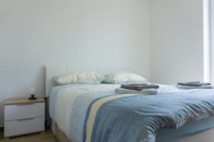 a bedroom with a bed with two towels on it at Nature View House with Sauna in Tolmin +51 photos