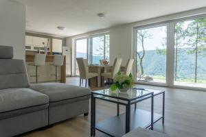 a living room with a couch and a table at Nature View House with Sauna in Tolmin
