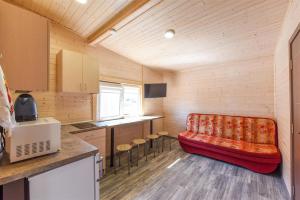 a living room with a red couch in a room at Ardonas in Šventoji