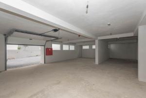 an empty parking garage with a large room with a door at Holiday Home Ivan in Makarska