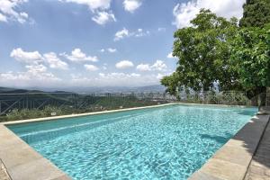 a swimming pool with a view of a city at Podere Capitignano in Borgo San Lorenzo