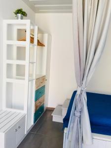 a room with a curtain next to a closet at Annika Deluxe Apartments in Symi