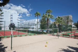 a volley ball court with palm trees and buildings at HM Martinique in Magaluf