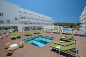 a hotel with a swimming pool and chairs and a building at HM Martinique in Magaluf