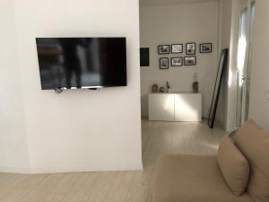 a living room with a flat screen tv on a wall at Lovely apt. only 300mt. Monza F1 Circuit-Park-Golf in Biassono