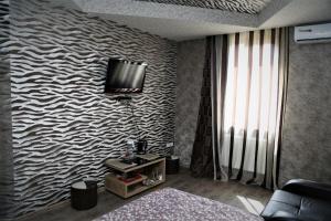 a living room with a tv on a wall at White House Mtskheta in Mtskheta
