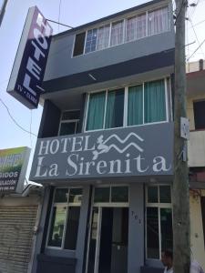 a hotel with a sign on the side of a building at La Sirenita in Veracruz