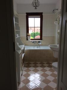 a bathroom with a tub and a toilet and a sink at Apartament Rodzinny in Kazimierz Dolny