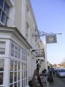 a building with a sign on the side of it at Crown Hotel Brackley in Brackley