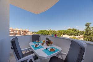a balcony with a table with food and drinks on it at Vista das Ondas - 208 in Albufeira